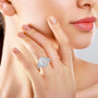 white jade and moissanite euro shank ring in rhodium over sterling silver worn on a hand