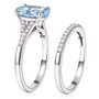 side view of aquamarine and oval moissanite bridal ring set in rhodium over sterling silver