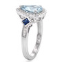 side view of aquamarine blue sapphire and moissanite halo ring in rhodium over sterling silver