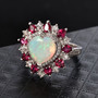ethiopian opal rhodolite garnet and zircon halo ring in rhodium over sterling silver shown for size comparison