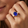 lab blue and white sapphire ring in 18k yellow gold over sterling silver worn on a hand