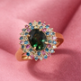 green sapphire and multi color lab diamond oval double halo ring in 14k yellow gold shown in a lifestyle photo