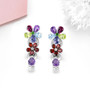 multi gemstone dangle earrings in rhodium over sterling silver shown in a lifestyle photo