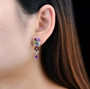 multi gemstone dangle earrings in rhodium over sterling silver worn on the ear