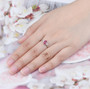 ruby and diamond 18k white gold ring worn on a hand