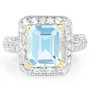 front view of sky blue topaz and white topaz halo ring in 18k yellow gold over sterling silver