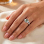 green sapphire and white zircon halo split shank ring in rhodium over sterling silver on hand model