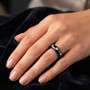 lab grown diamond three stone ring in solid black jade with rhodium over sterling silver bezels on hand model