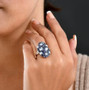 iolite and rainbow moonstone cluster ring in rhodium over sterling silver worn on a hand