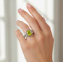 peridot green sapphire and white zircon halo ring in two tone rhodium over sterling silver on hand model