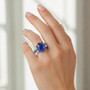 kyanite sapphire and zircon halo ring in two-tone rhodium over sterling silver worn on a hand