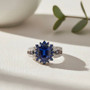 kyanite sapphire and zircon halo ring in two-tone rhodium over sterling silver shown in a lifestyle photo