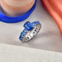 kyanite and white zircon eternity ring in rhodium over sterling silver shown in a lifestyle photo
