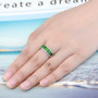 chrome diopside and white zircon band ring in rhodium over sterling silver worn on a hand