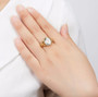 prasiolite oval fleur-de-lis ring in 18k yellow gold over sterling silver worn on a hand