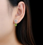 peridot garnet and white zircon dangle earrings in rhodium over sterling silver worn on the ear