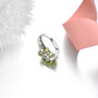 close up of peridot cluster ring in rhodium over sterling silver