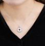 garnet cabochon and mother of pearl necklace in rhodium over sterling silver worn around the neck