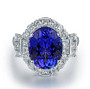 full view of tanzanite and diamond halo ring in 18k white gold