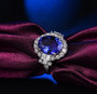 tanzanite and diamond halo ring in 18k white gold shown in a lifestyle photo