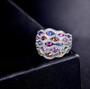 close up of multi color sapphire and diamond 14k white gold wide band ring