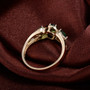 side view of tsavorite garnet and diamond trilogy 14k yellow gold ring