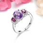 amethyst rhodolite garnet and white zircon rhodium over sterling silver trilogy ring shown in a lifestyle photo