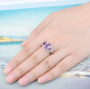amethyst rhodolite garnet and white zircon rhodium over sterling silver trilogy ring worn on a hand