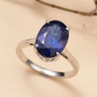 kyanite oval solitaire ring in 950 platinum shown in a lifestyle photo