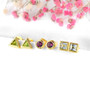 close up of peridot trillion bezel set stud earrings in 18k yellow gold over sterling silver