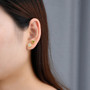 peridot trillion bezel set stud earrings in 18k yellow gold over sterling silver