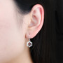 dancing garnet and white zircon dangle earrings in rhodium over sterling silver