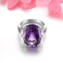amethyst and white zircon oval solitaire ring in rhodium over sterling silver shown in a lifestyle photo