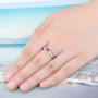 ruby and white zircon double band ring in rhodium over sterling silver worn on a hand
