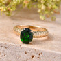chrome diopside oval solitaire openwork 10k yellow gold ring shown in a lifestyle photo