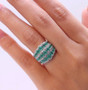 zambian emerald and moissanite multi row band ring in rhodium over sterling silver on hand model