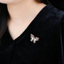 multi gemstone butterfly brooch in 18k yellow gold over sterling silver shown being worn