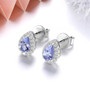 side view of natural tanzanite and white zircon halo pear stud earrings in rhodium over 925 sterling silver