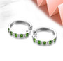 side view of natural green chrome diopside and white zircon hoop earrings in rhodium over sterling silver