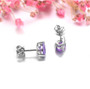 close up of amethyst 7x5mm pear shape stud earrings in rhodium over sterling silver