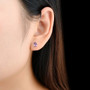 amethyst 7x5mm pear shape stud earrings in rhodium over sterling silver worn on the ear