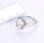 rose quartz and white zircon halo ring in rhodium over sterling silver