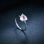close up of rose quartz 8mm trillion solitaire ring in rhodium over sterling silver
