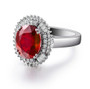 side view of lab ruby and diamond halo ring in 18k white gold