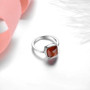 side view of hessonite garnet cabochon sugar loaf solitaire rhodium over sterling silver ring