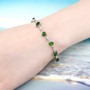 chrome diopside mixed shapes station bracelet in rhodium over sterling silver worn on a wrist