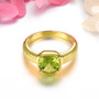 close up of peridot solitaire ring in 18k yellow gold over sterling silver ring