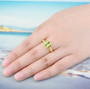 peridot solitaire ring in 18k yellow gold over sterling silver ring worn on a hand