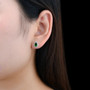 chrome diopside pear halo stud earrings in rhodium over sterling silver worn on the ear