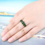 chrome diopside band ring in rhodium over sterling silver worn on a hand
